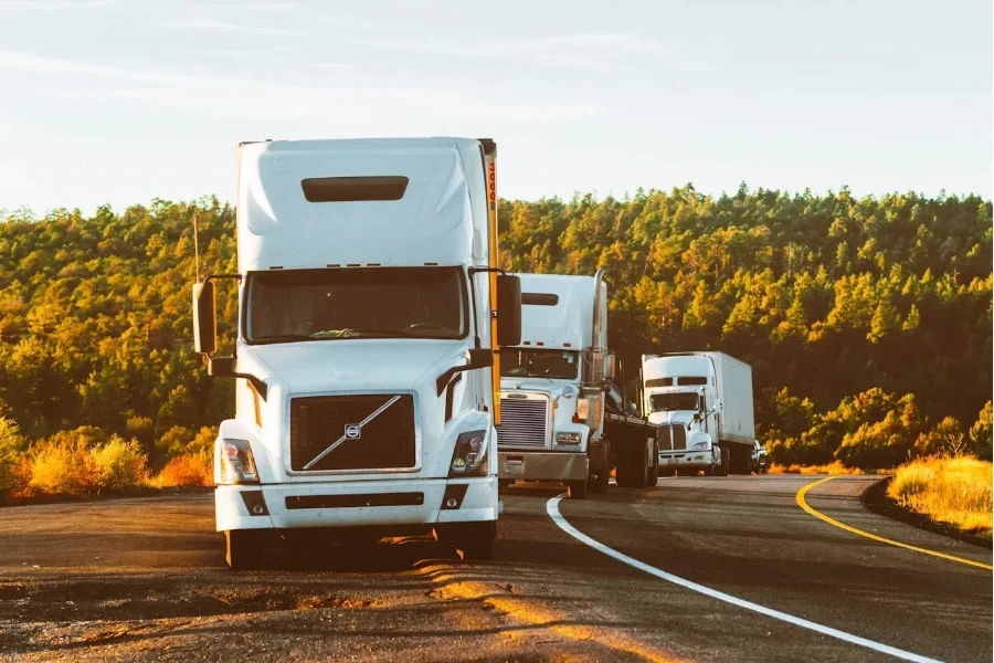 Multiple business trucks on the side of a road