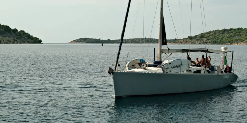 People sailing a small yacht at sea