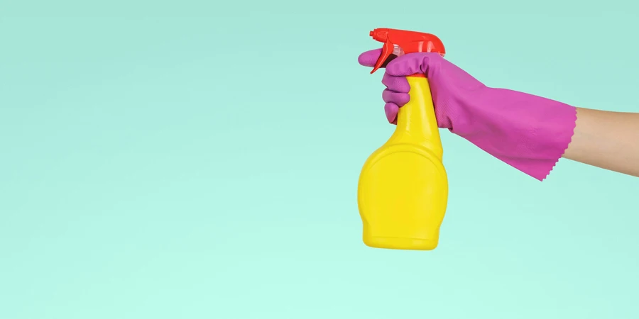 person holding yellow plastic spray bottle