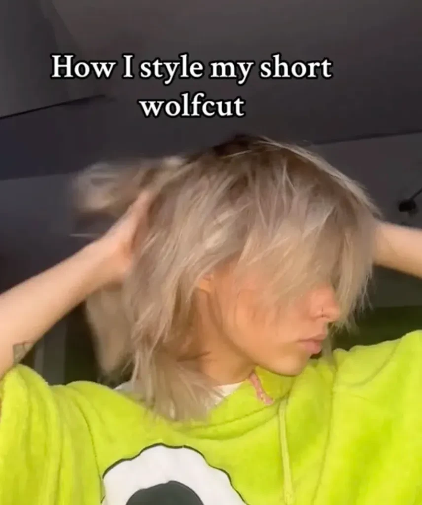 Person styling their wolf cut on TikTok