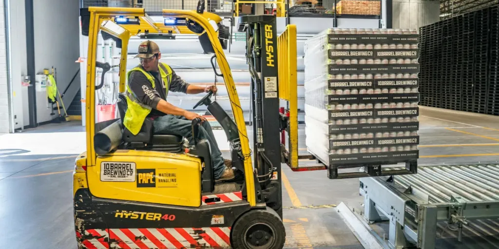 Person using a forklift in a warehouse