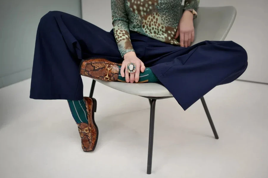 Stylish woman in animal print loafers and colored socks