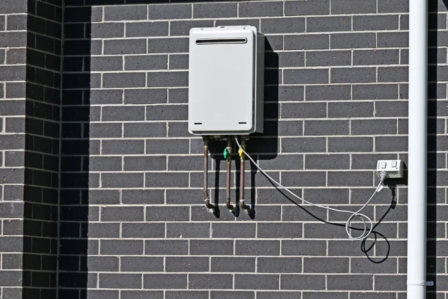 tankless gas water heater mounted on a wall in a home