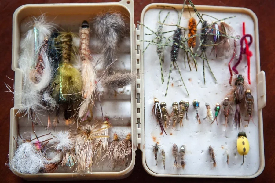 White tackle box full of various fishing lures