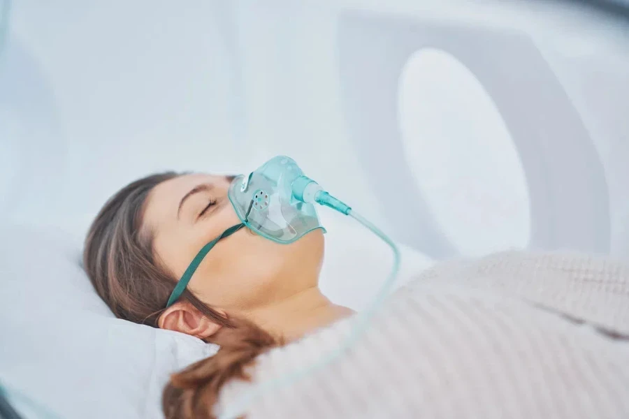 Woman laying in a horizontal hyperbaric oxygen chamber