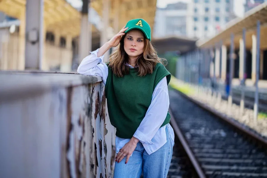 Woman posing in an oversized green vest