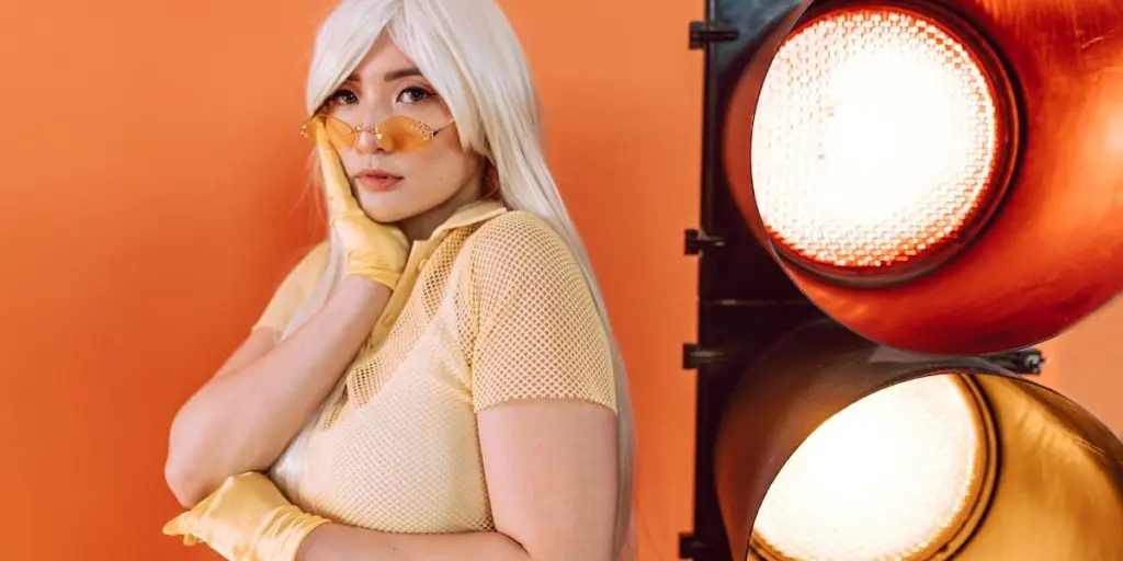 Woman posing near lights in a white wig