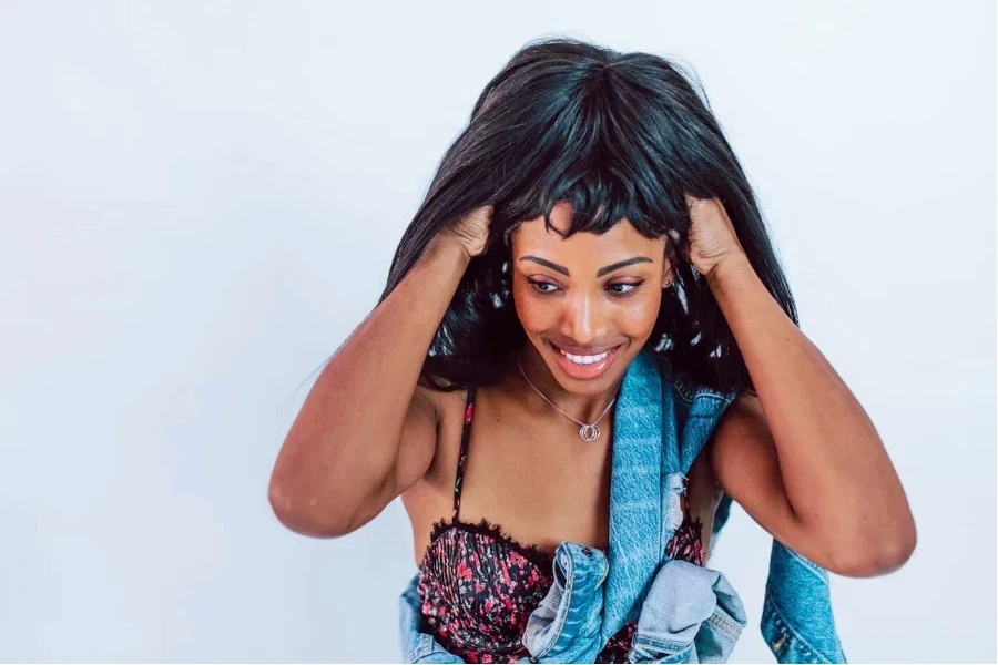 Woman putting on a black lace wig