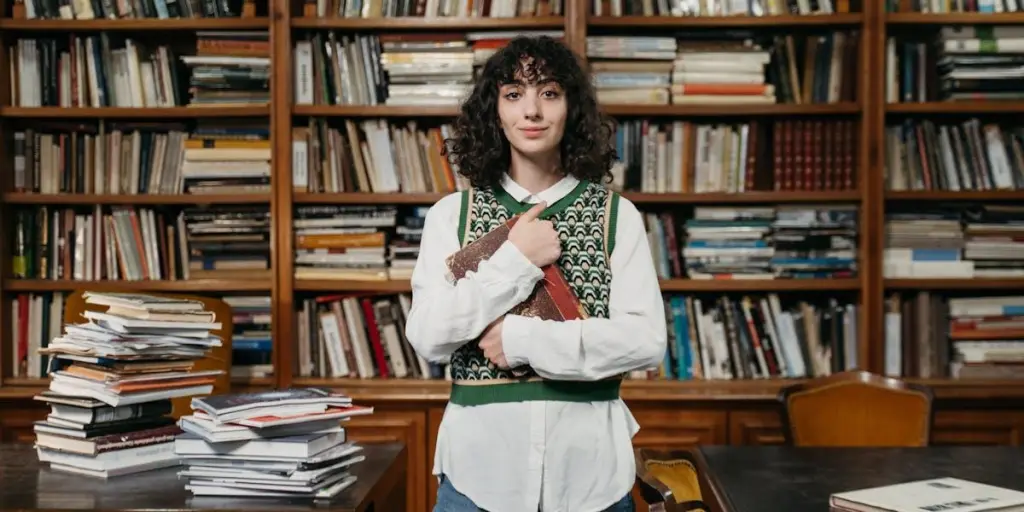 Woman wearing a knitted vest holding a book