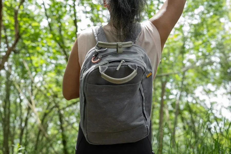 Woman wearing green travel bag with small pockets