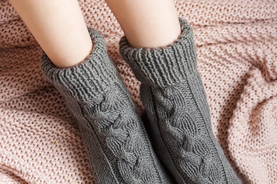 Young lady in cozy knitted socks