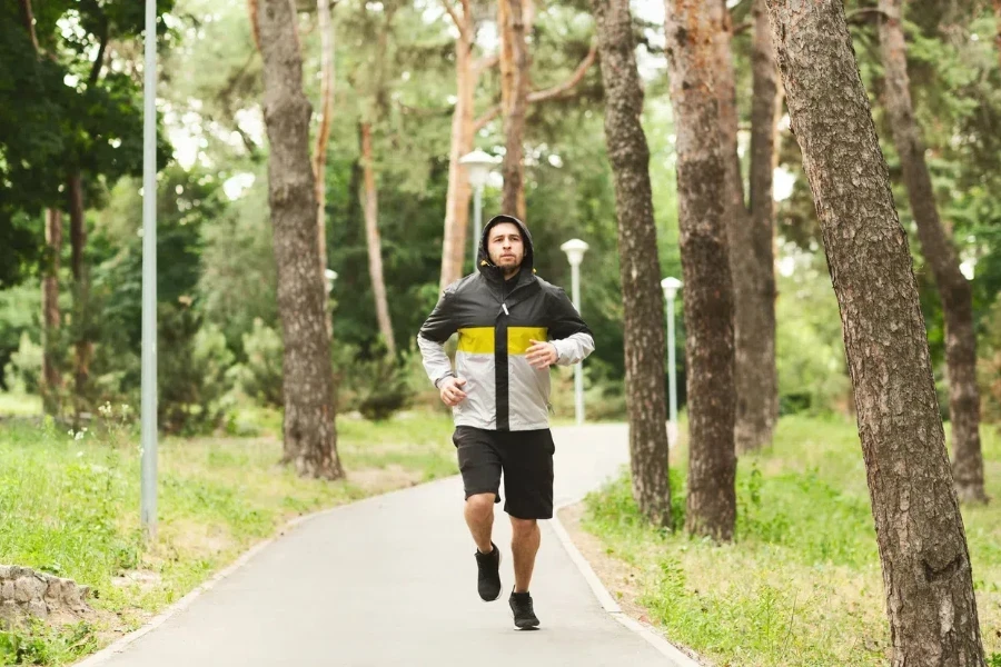 Young man jogging in a water-resistant windbreaker