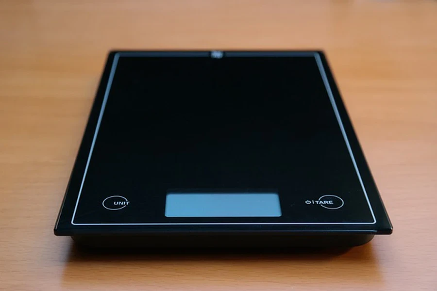 A black digital scale on a table