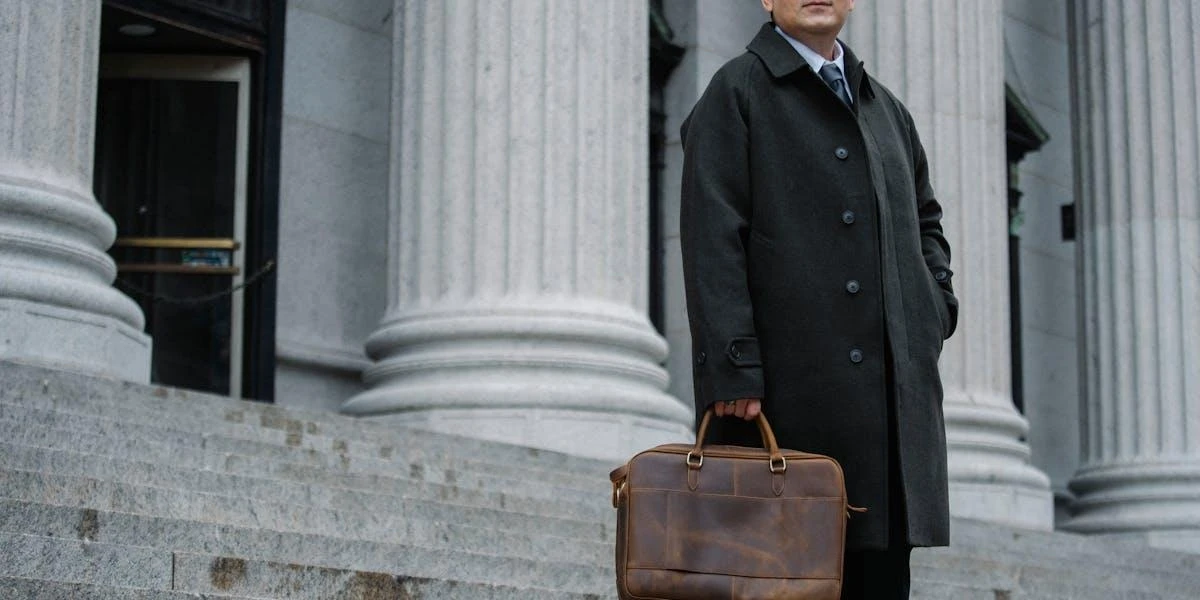 A businessman wearing a sleek black coat