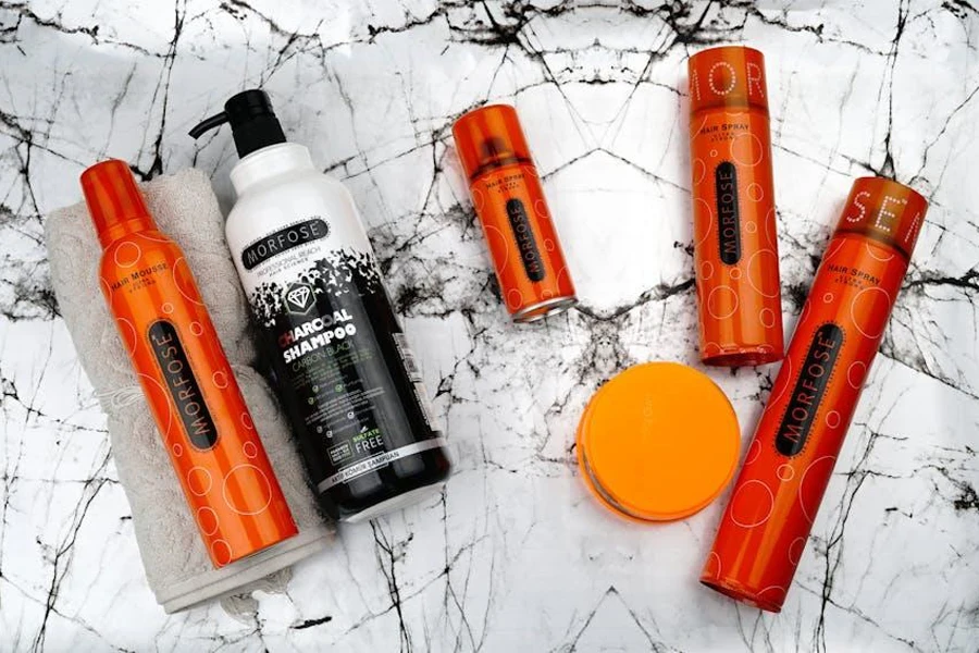 A collection of orange and black hair shampoos