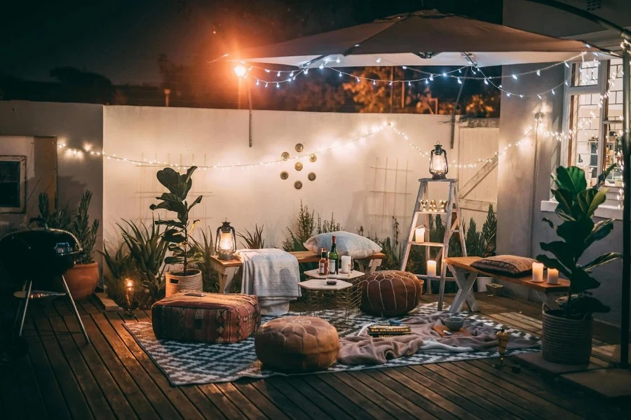 A cute setup with lights, candles, and cushions