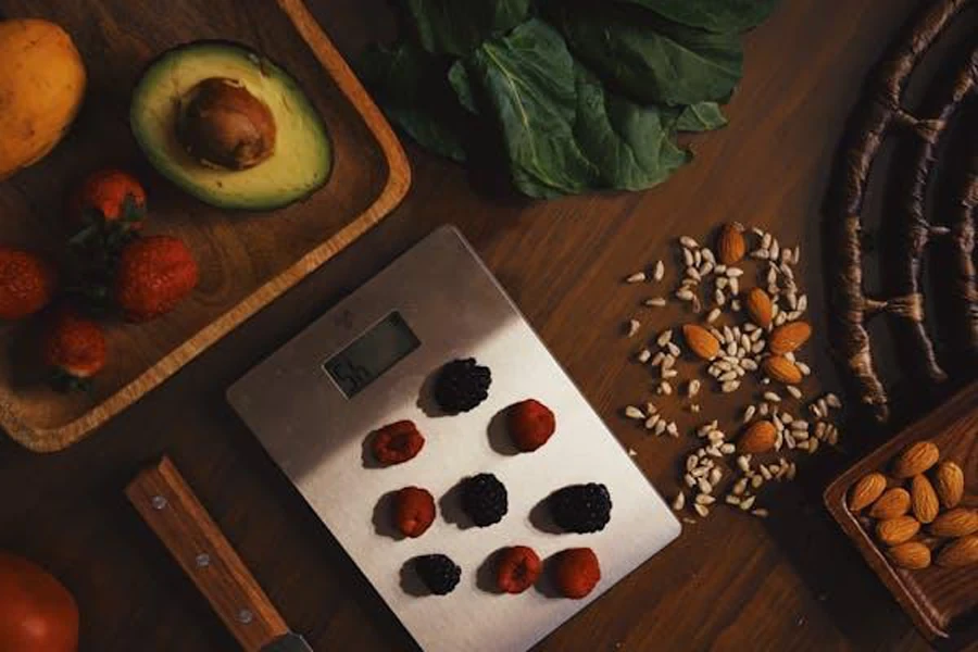 A digital scale with berries on top