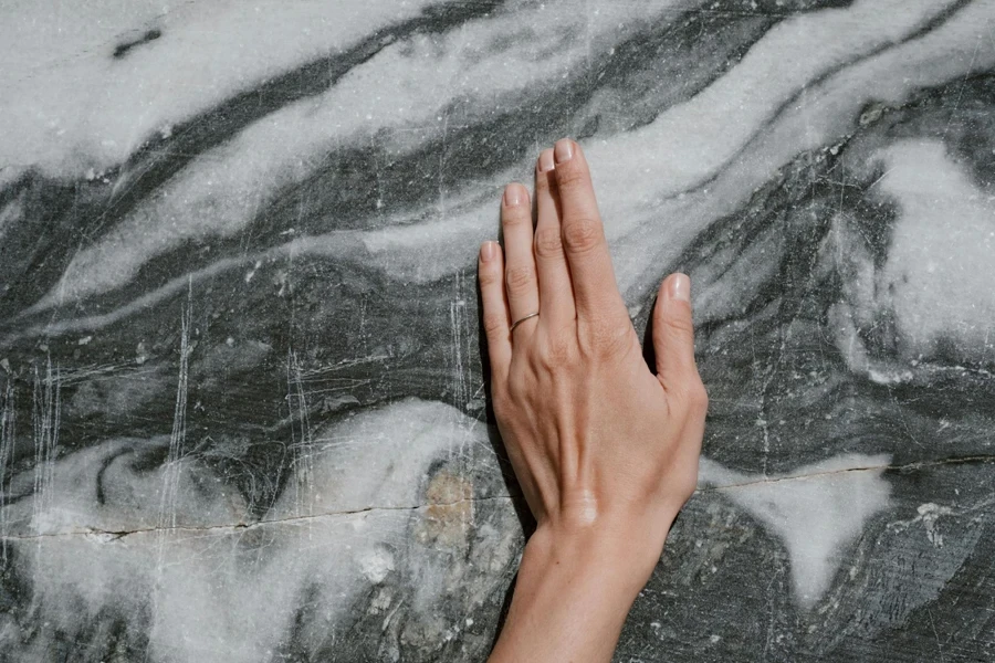 A hand on a granite slab