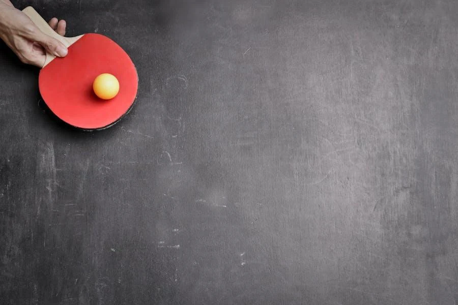 A holding a table tennis paddle and a yellow ball