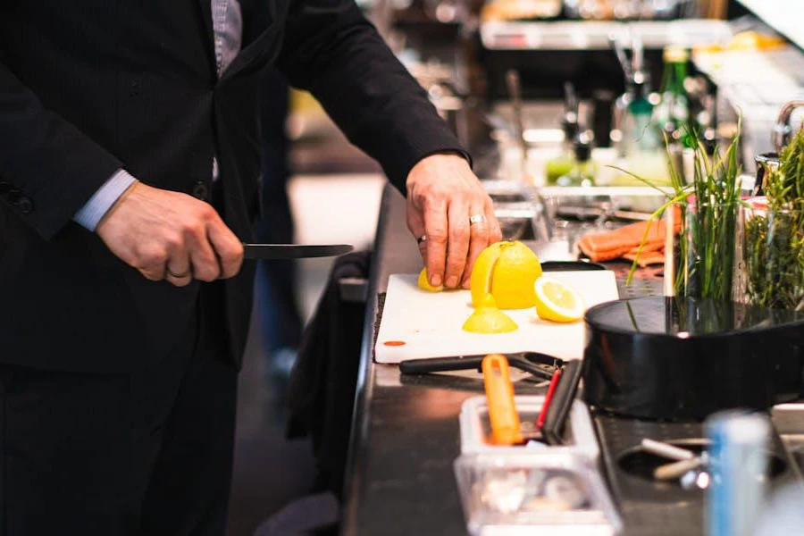 A man cutting lemons for a cocktail