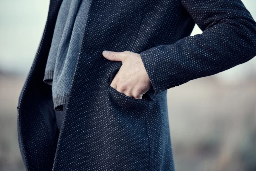 A man in a navy blue wool overcoat