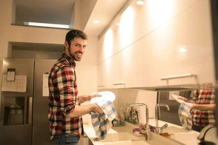 A man wiping wet dishes