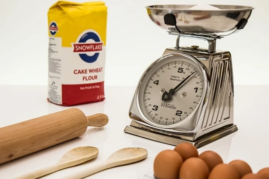 A mechanical kitchen scale besides baking ingredients