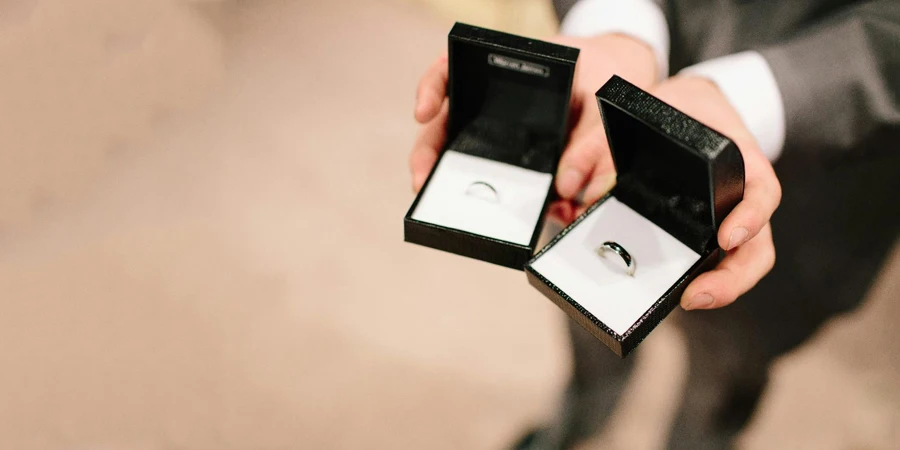 A person holding a box with a ring in it