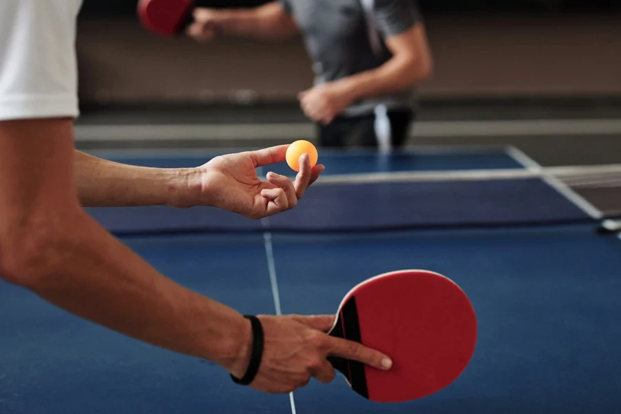 A person holding the table tennis paddle using the penholder grip