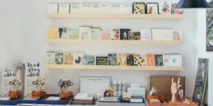 A shelf with books and cards