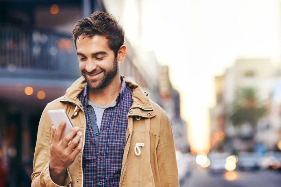 A smiling man in a brown technical jacket