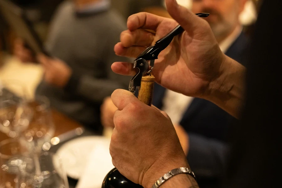 A waiter using a small wine Bottle Opener