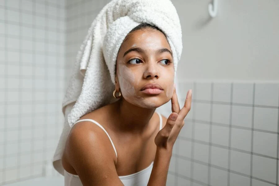 A woman applying face cream