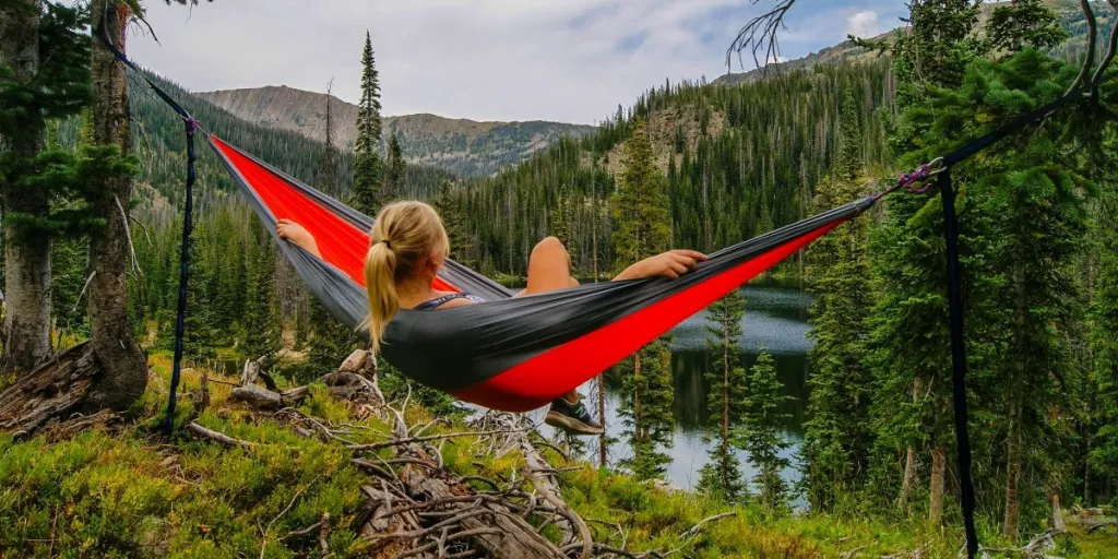 A woman on a hammock near a river