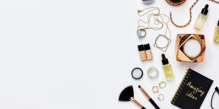 Assorted beauty products and jewelry against white background