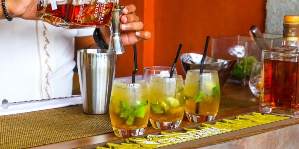 Bartender preparing a rum drink with bar tools