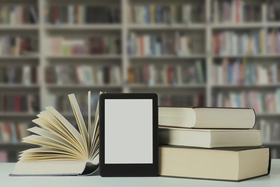 Books and modern e-book on table