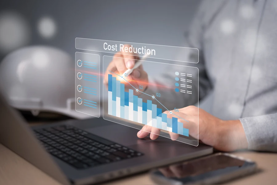 Businessman pointing a falling cost reduction graph