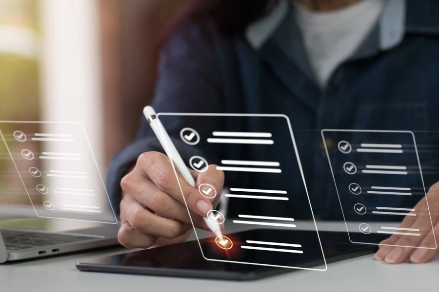 Businesswoman ticking a checklist on a tablet