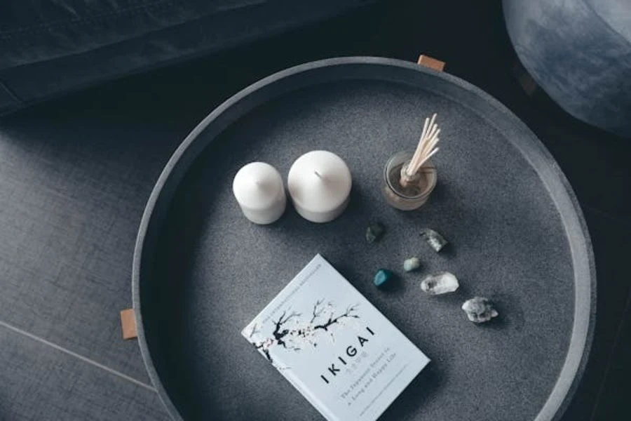 Candles and a book in a black dish