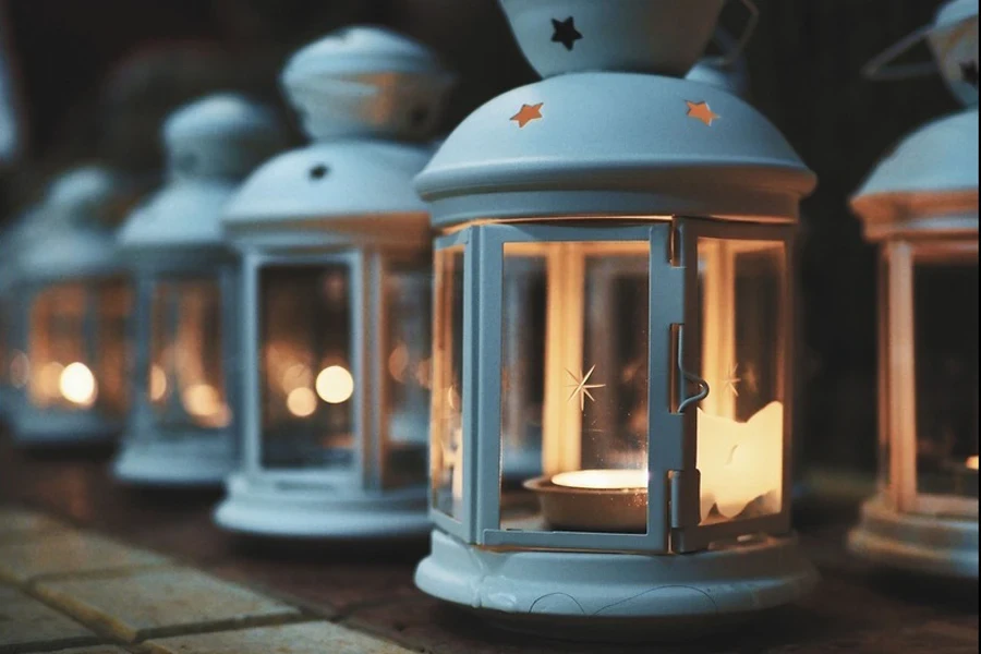 Candles burning inside white lanterns