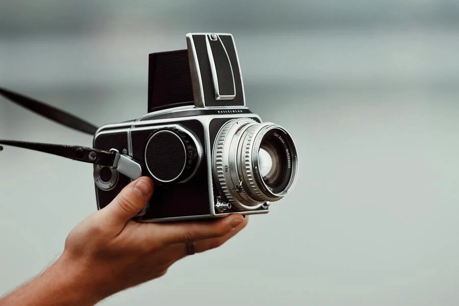 Close-up of hands holding a camera