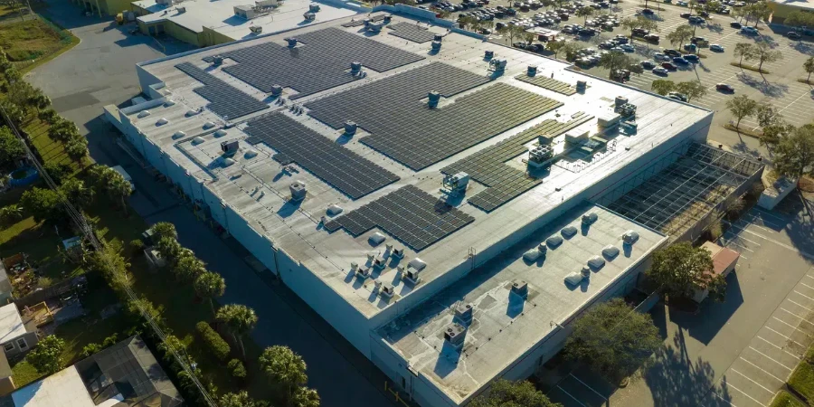 Electric photovoltaic solar panels installed on shopping mall building rooftop