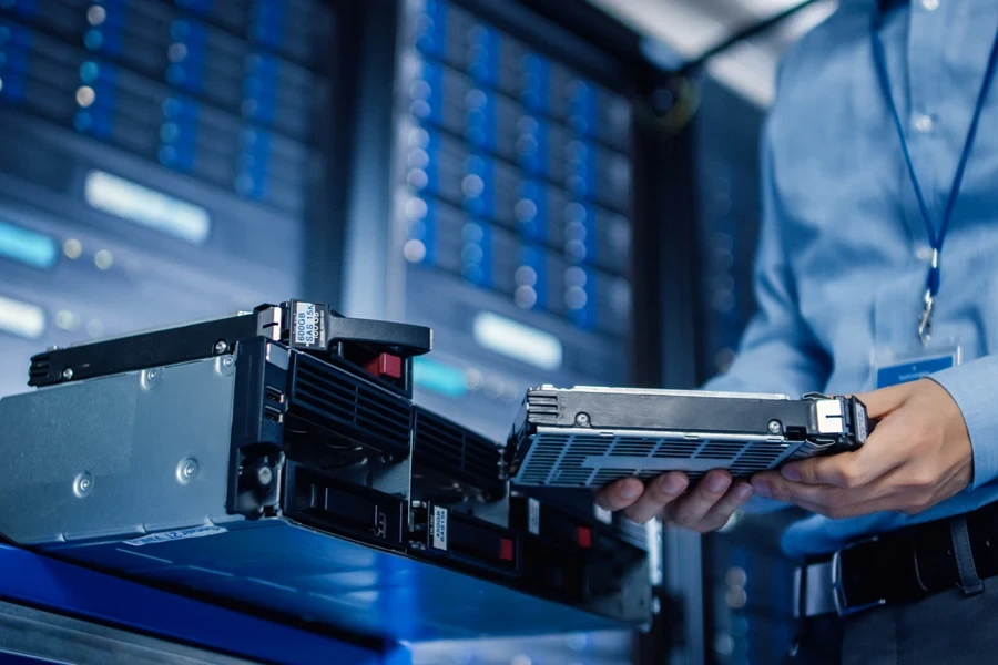 Engineer holding new HDD for server rack