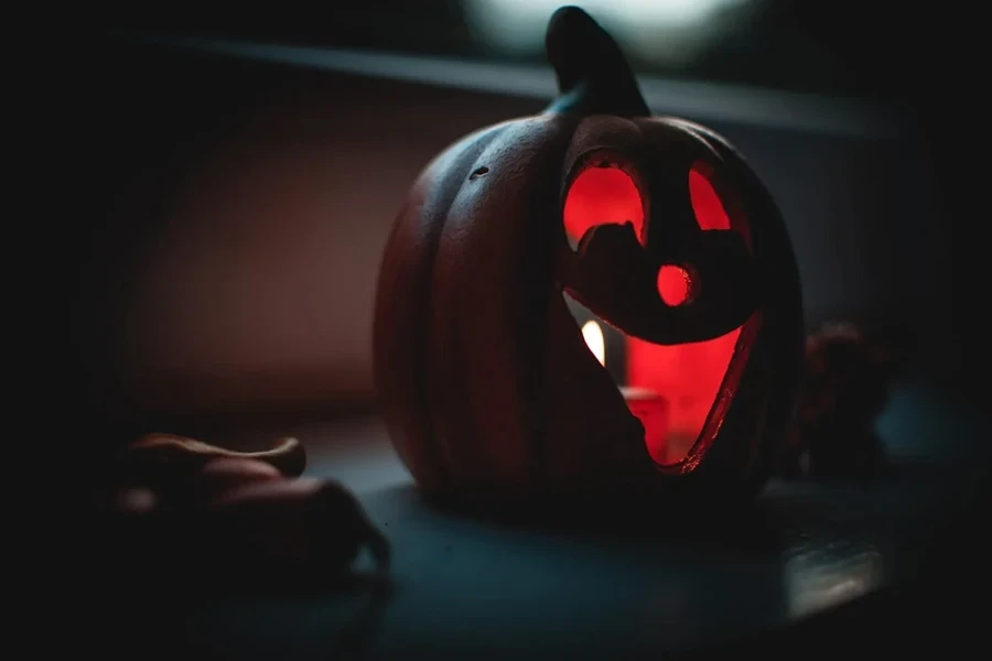 Ghoulish pumpkin carving with a red candlelight