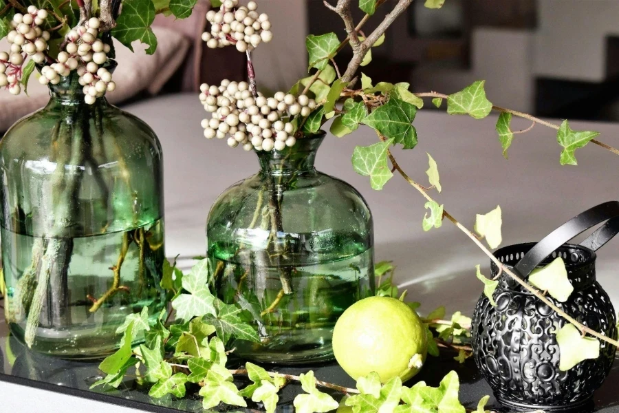 Green Leaved Plants in Green Clear Glass Vase