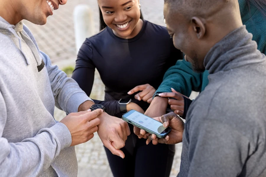 Group of people looking at their smartwatches