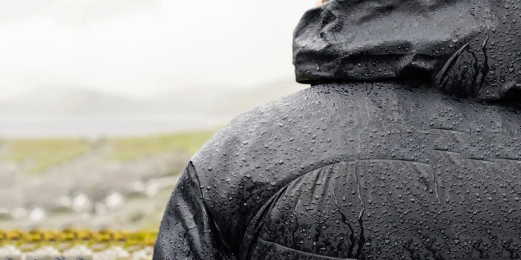 Heated jacket protecting man from rain