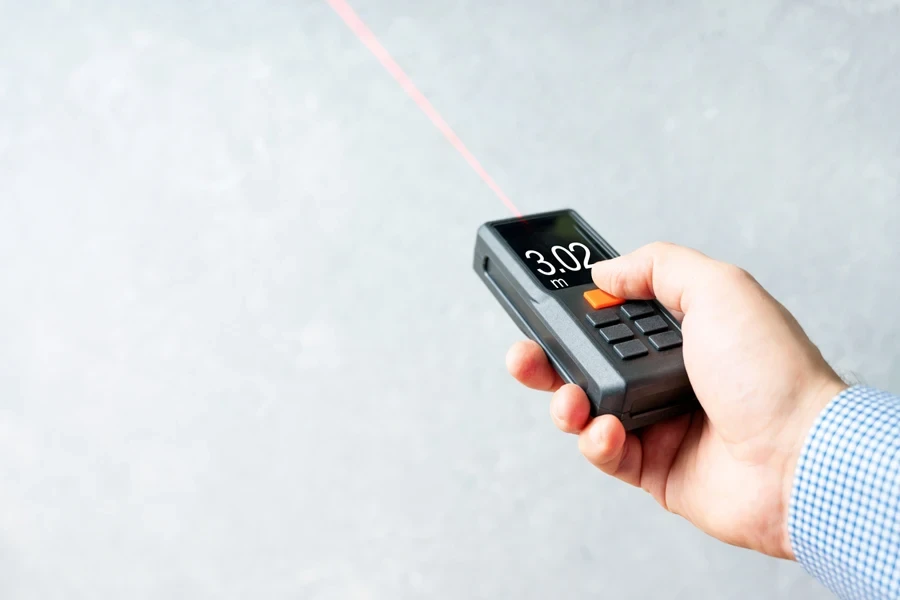 Laser tape measure in male hand