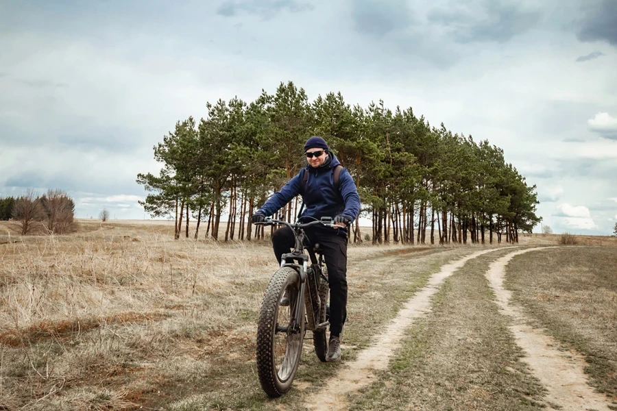 Man riding a bike with a field jacket